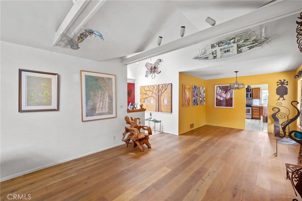 1166 Longfellow Drive Manhattan Beach, CA 90266 - Photo 19 of 47 a view of a livingroom with furniture workspace and wooden floor