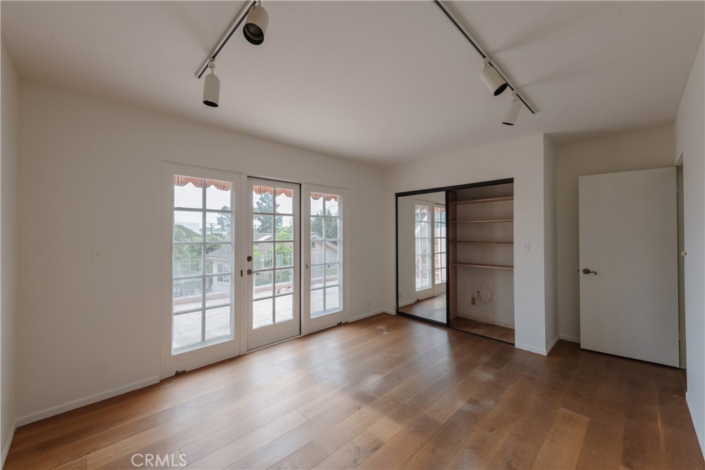 1166 Longfellow Drive Manhattan Beach, CA 90266 - Photo 22 of 47 wooden floor in an empty room with a window