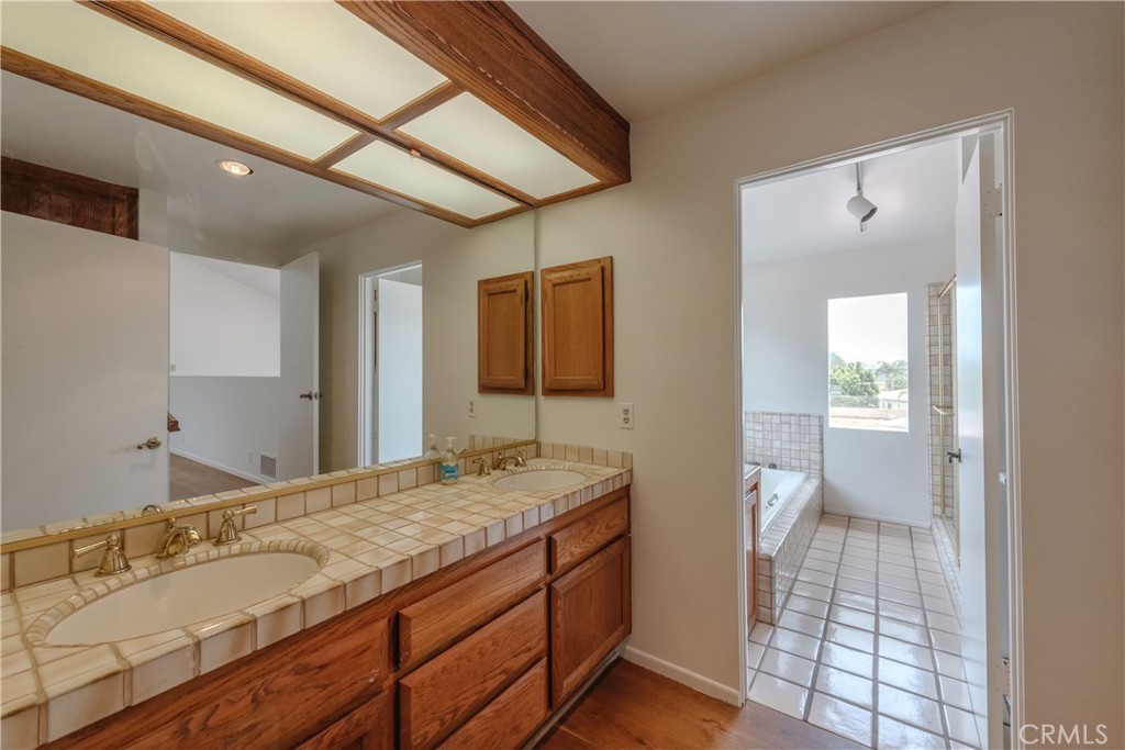 1166 Longfellow Drive Manhattan Beach, CA 90266 - Photo 26 of 47 a bathroom with a granite countertop sink and a mirror