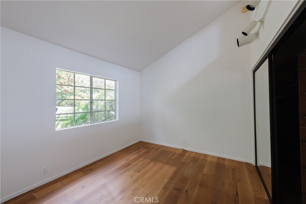 1166 Longfellow Drive Manhattan Beach, CA 90266 - Photo 28 of 47 an empty room with wooden floor and windows