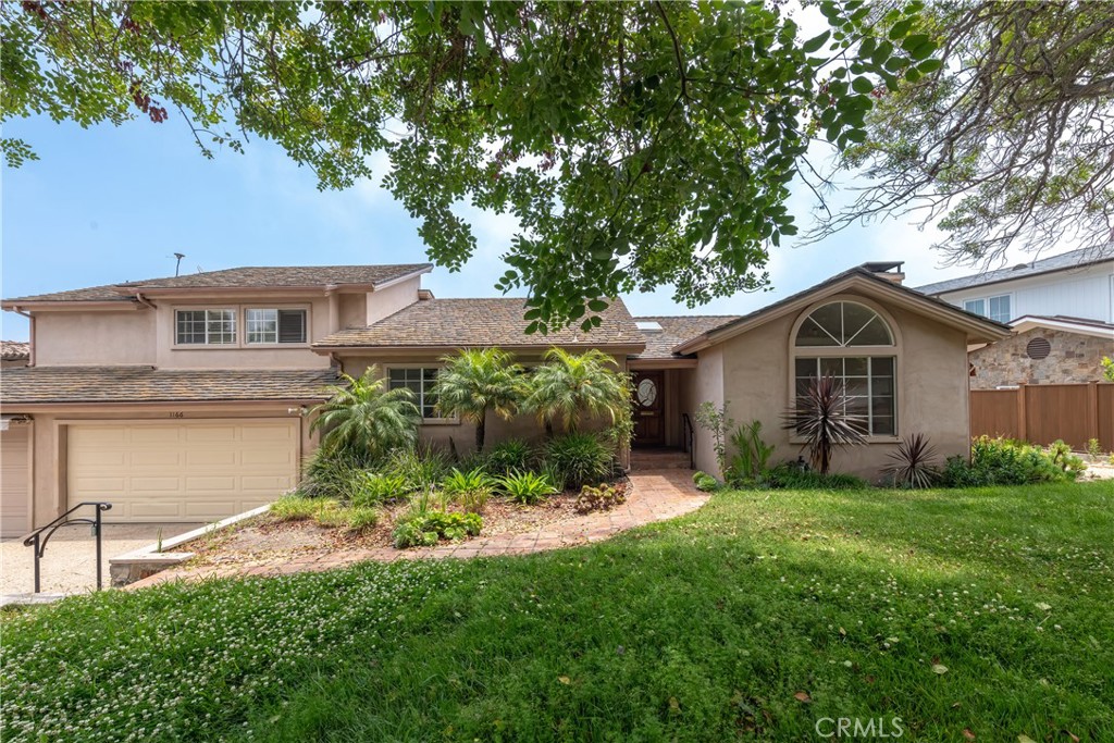 1166 Longfellow Drive Manhattan Beach, CA 90266 - Photo 47 of 47 a front view of a house with a yard and garage