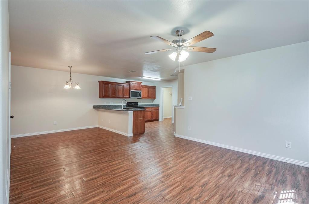452 Canvas Court Crowley, TX 76036 - Photo 2 of 11 a view of a kitchen with a sink and wooden floor