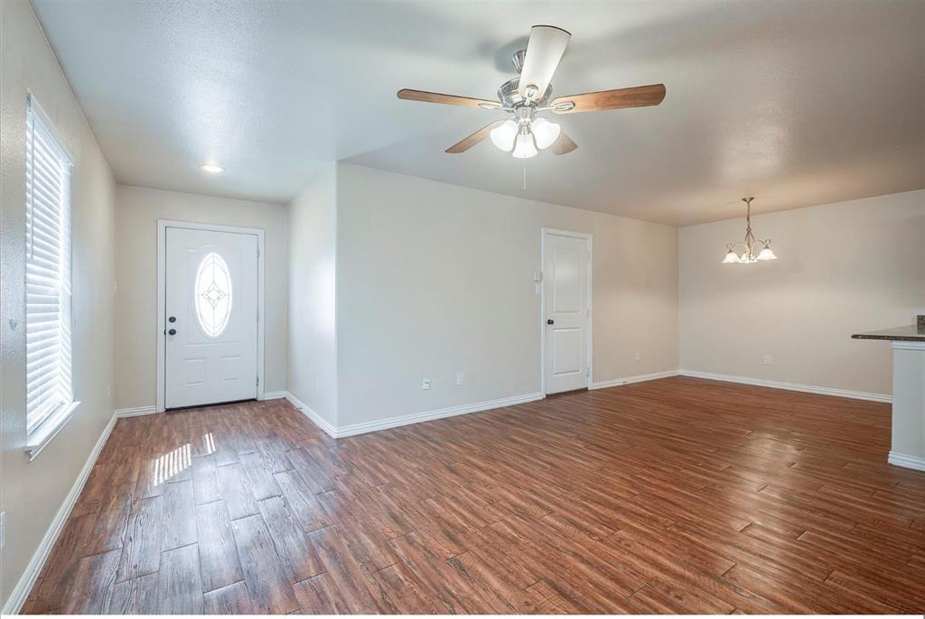 452 Canvas Court Crowley, TX 76036 - Photo 4 of 11 wooden floor in an empty room with a window