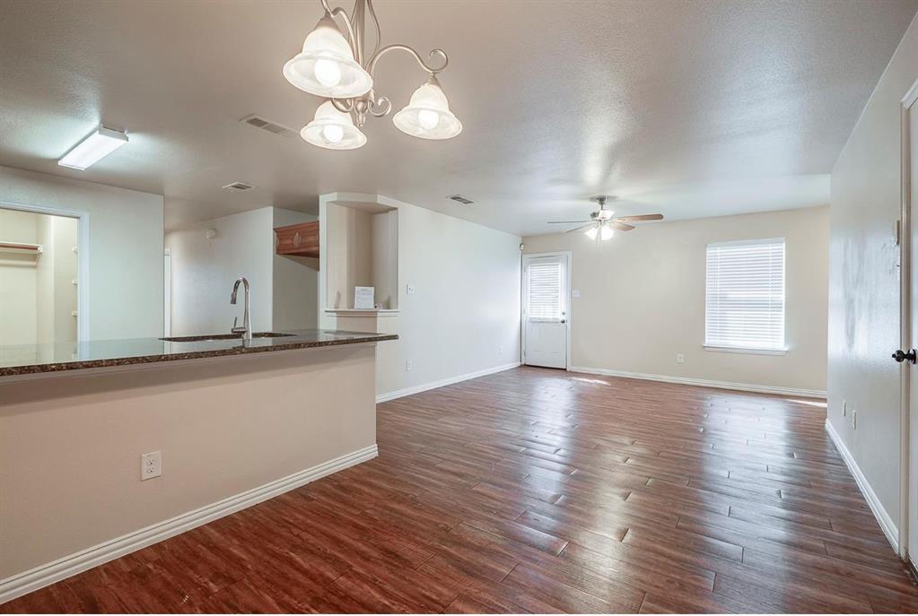 452 Canvas Court Crowley, TX 76036 - Photo 5 of 11 a view of an empty room with wooden floor and a window