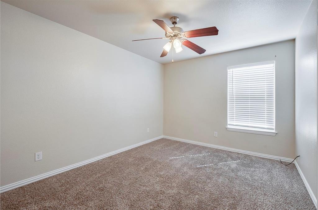 452 Canvas Court Crowley, TX 76036 - Photo 10 of 11 an empty room with window and chandelier fan