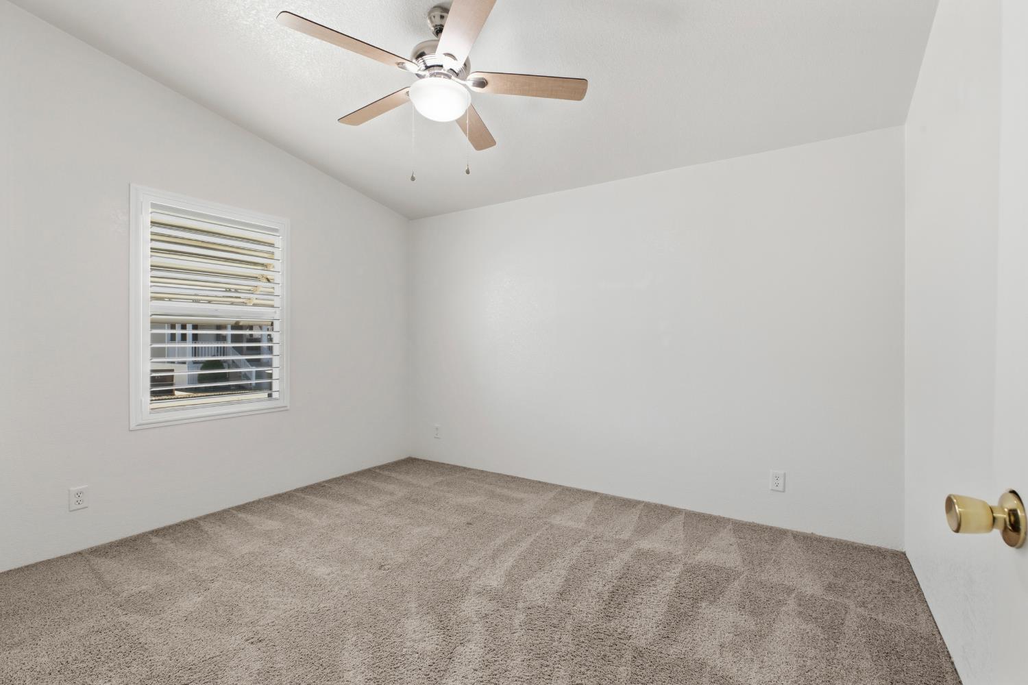 2113 Barrington Lane Modesto, CA 95350 - Photo 12 of 32 an empty room with a window and a fan