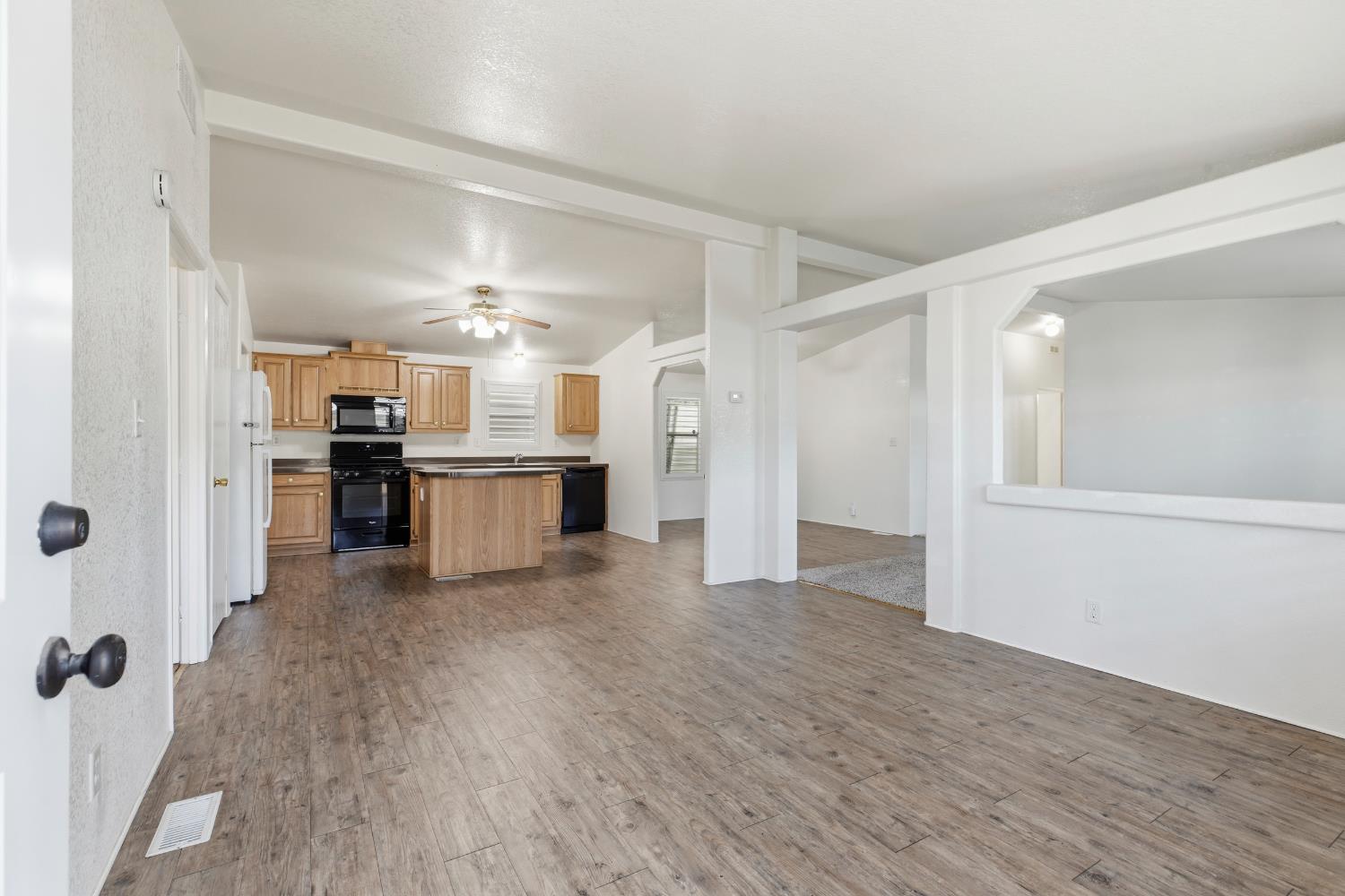 2113 Barrington Lane Modesto, CA 95350 - Photo 5 of 32 a view of a kitchen with a refrigerator a stove top oven