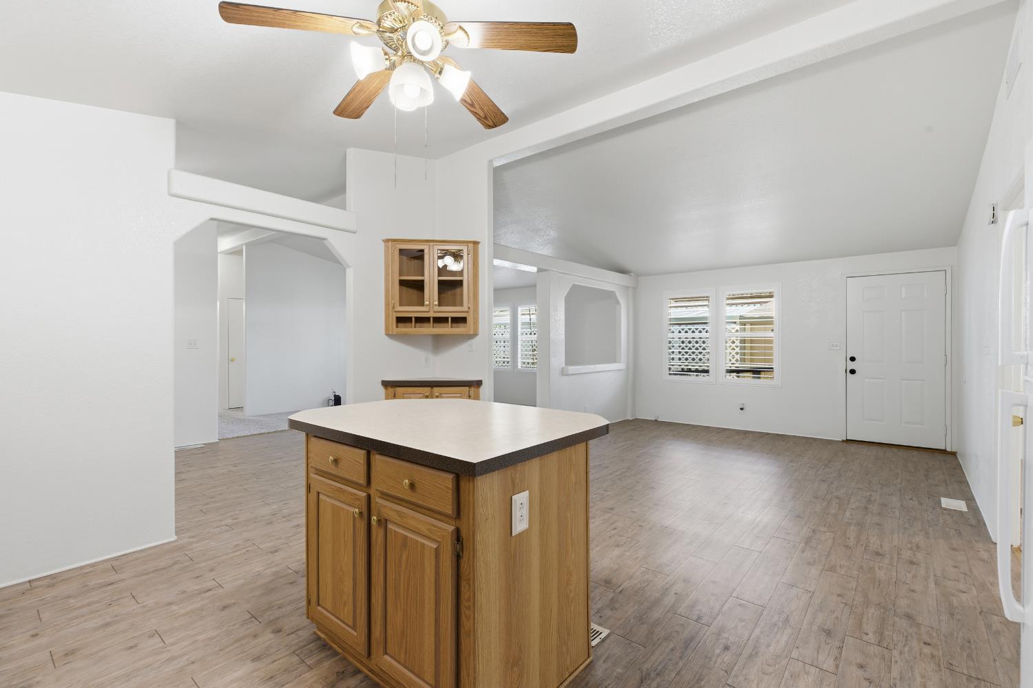 2113 Barrington Lane Modesto, CA 95350 - Photo 6 of 32 a kitchen with a wooden floor and window