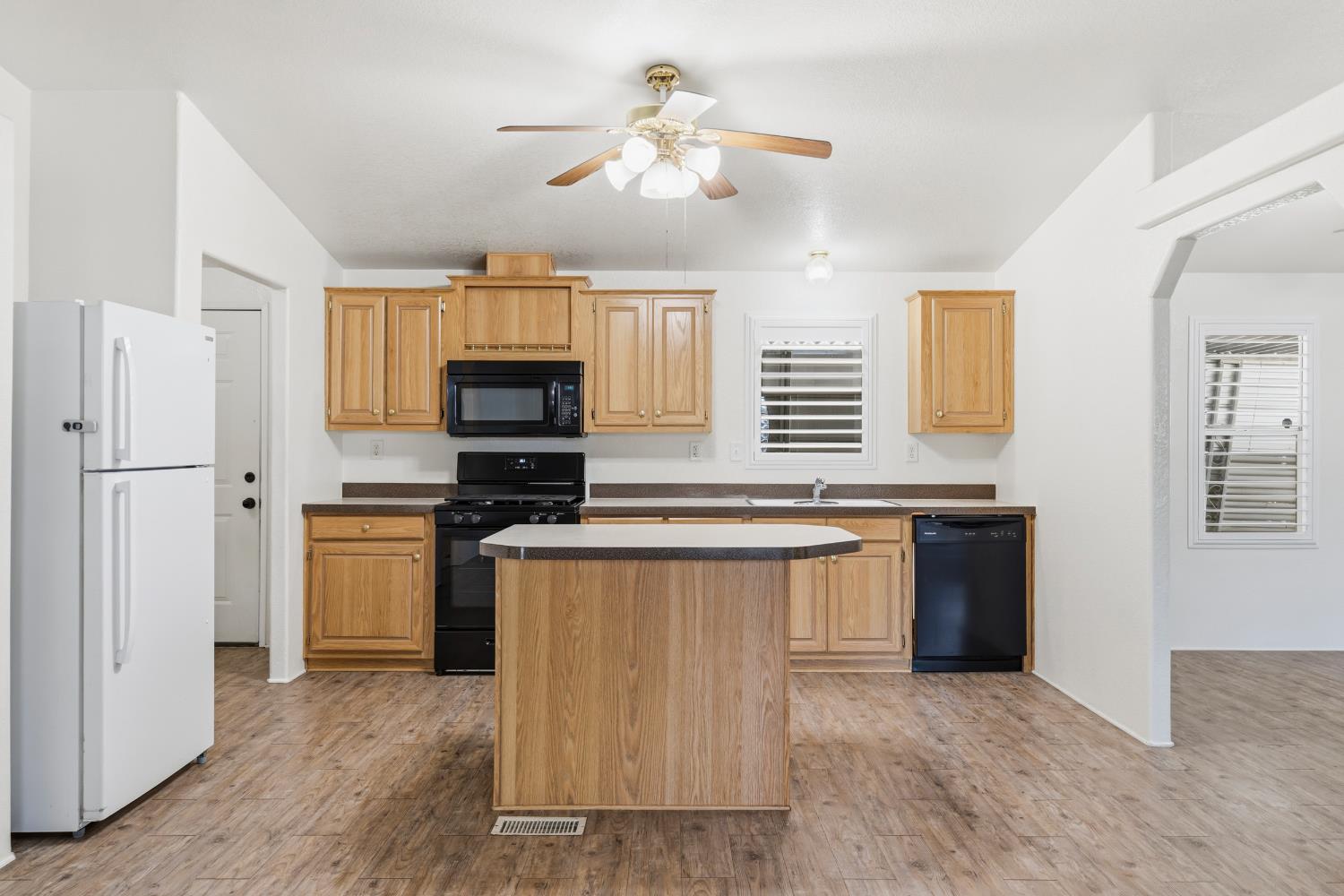 2113 Barrington Lane Modesto, CA 95350 - Photo 7 of 32 a kitchen with stainless steel appliances granite countertop a stove a refrigerator and a microwave