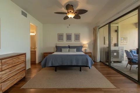 a bedroom with a bed chandelier and a window