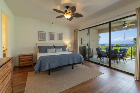 a bedroom with a bed and a chandelier with exposed radiator