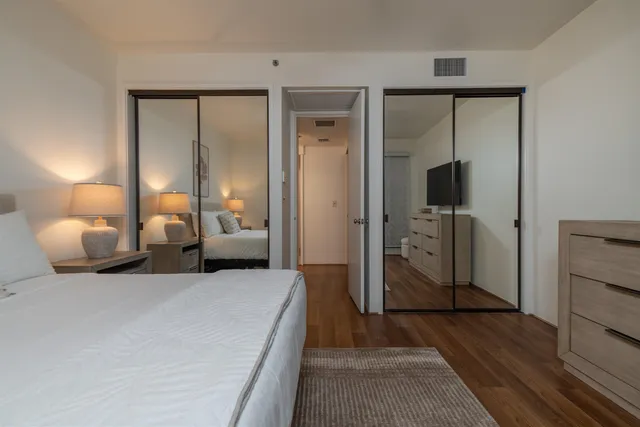 a bedroom with a bed and a mirror