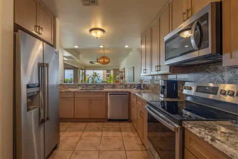 a kitchen with a sink cabinets and stainless steel appliances