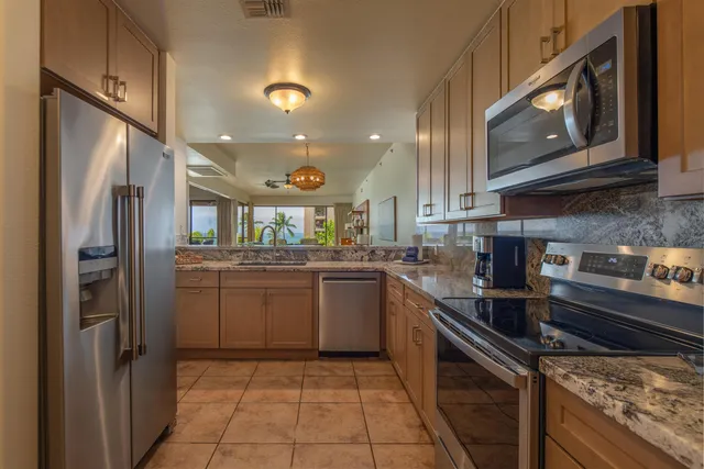 a kitchen with a sink cabinets and stainless steel appliances