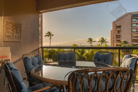 a view of a chairs and table in the balcony