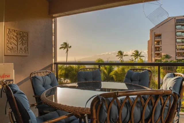 a view of a chairs and table in the balcony