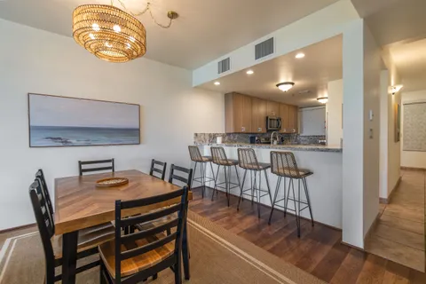 a view of a dining room with furniture and wooden floor
