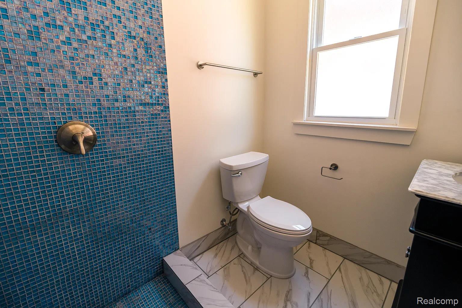 2045 Calvert Avenue Detroit, MI 48206 - Photo 27 of 41 Bathroom with vanity, tiled shower, and marble look tiles