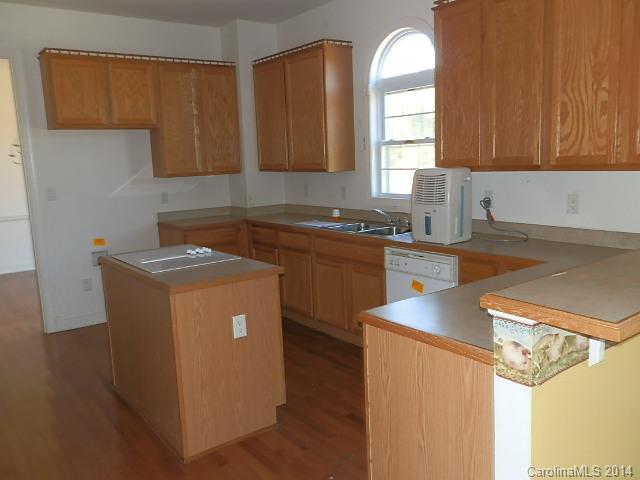 700 Mt Vernon Road Woodleaf, NC 27054 - Photo 4 of 24 a kitchen with sink cabinets and window