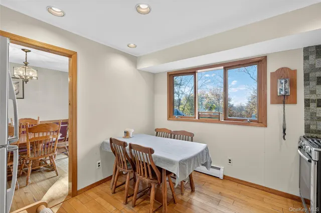 a view of a dining room with furniture window and wooden floor