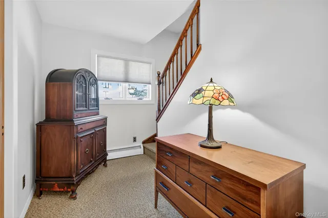 a view of hall way with furniture and stairs