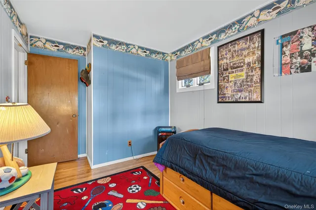 a bedroom with a bed dresser and a window