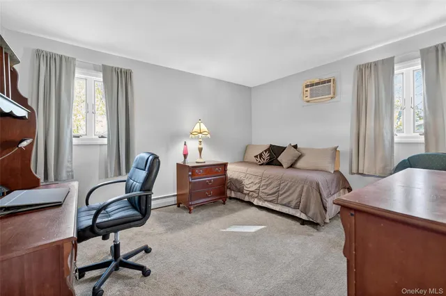 a bedroom with a bed chair and a window