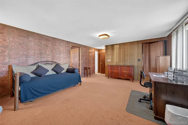 a living room with furniture and a pool table