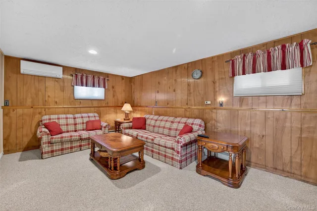 a living room with furniture a couch and a wall painting