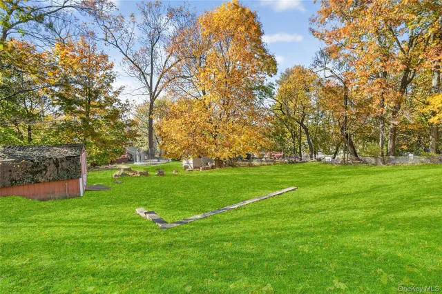 a view of a big yard with large trees