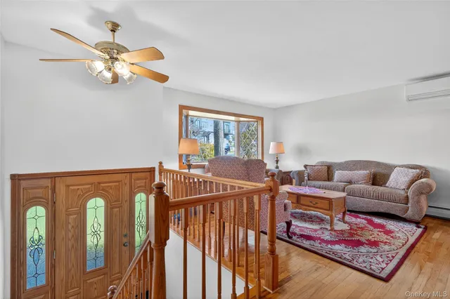 a living room with furniture a rug and a chandelier