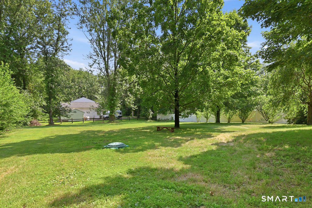 630 South Elm Street Wallingford, CT 06492 - Photo 3 of 30 a backyard of a house with table and chairs