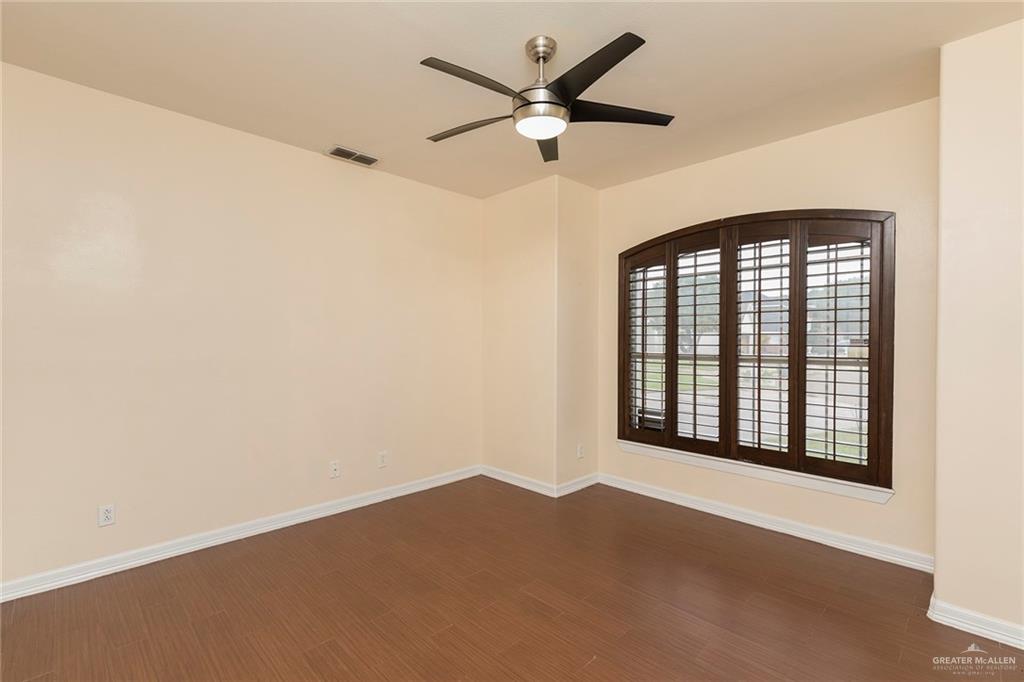 2001 Quail Lane Mission, TX 78572 - Photo 11 of 28 Room featuring wood-finish flooring, light-colored walls, and a modern ceiling fan with integrated lighting