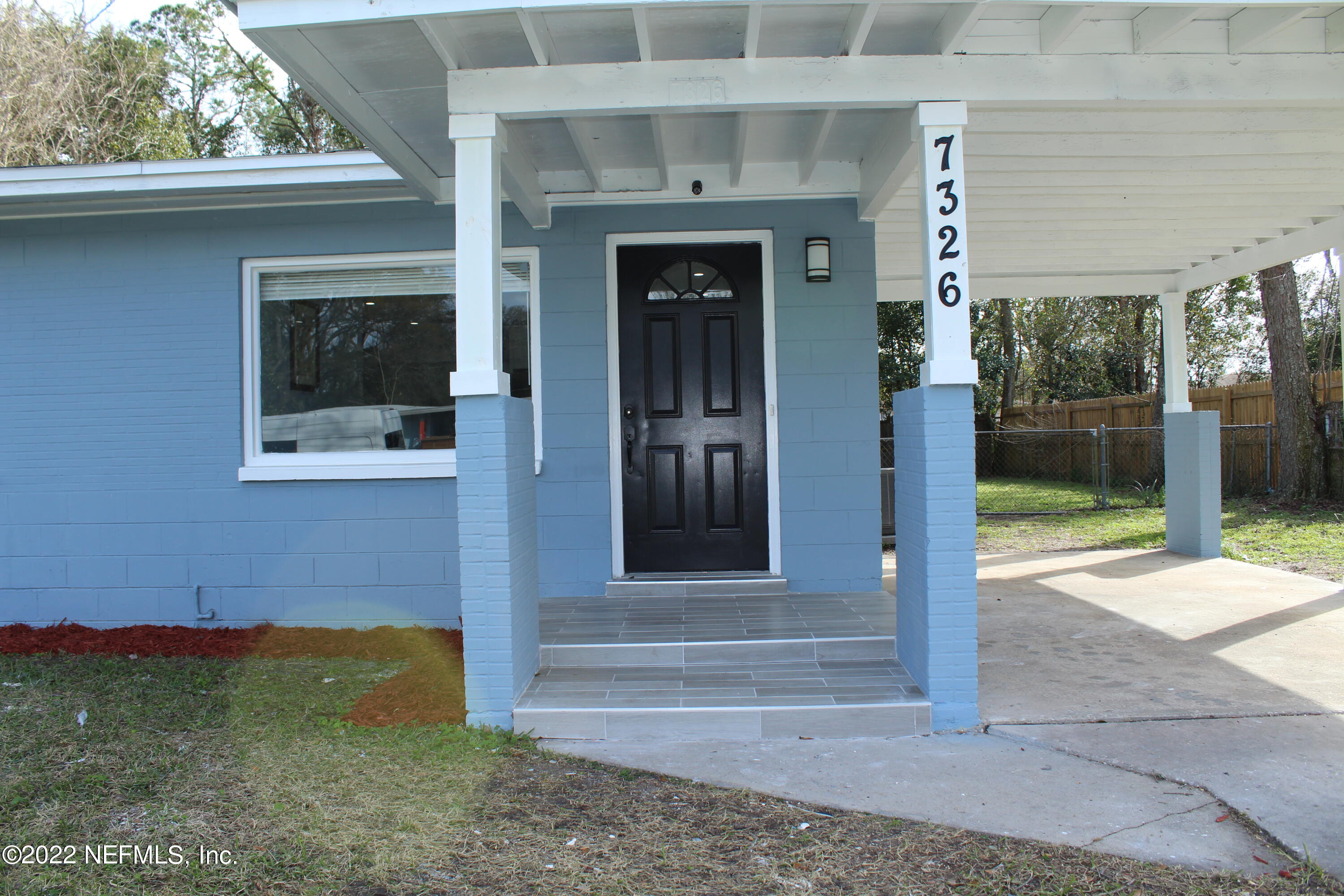 7326 Strato Road Jacksonville, FL 32210 - Photo 2 of 35 a front view of a house with a yard