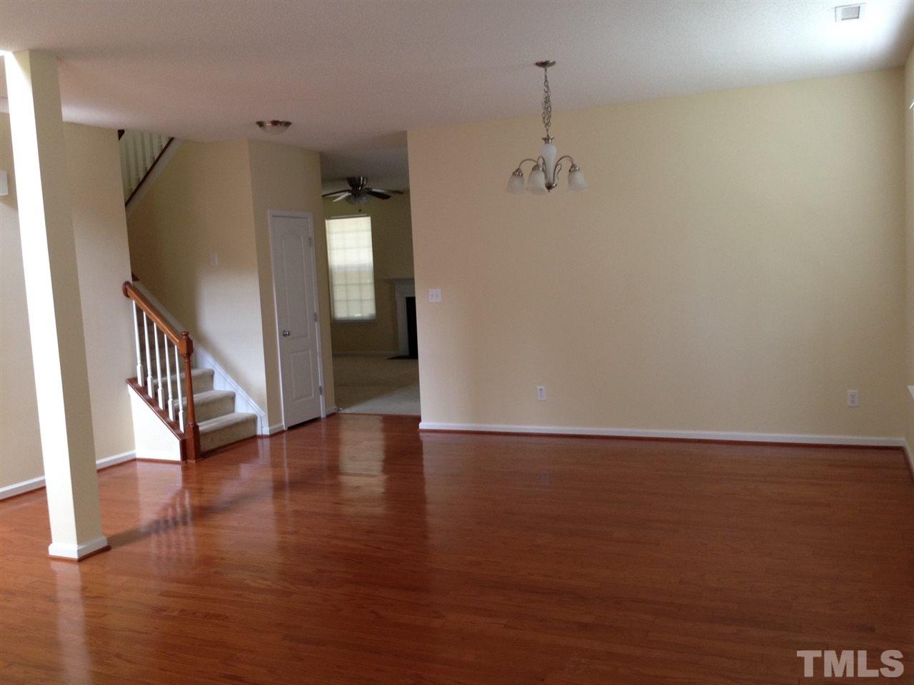 3433 Dutchman Road Raleigh, NC 27610 - Photo 3 of 22 a view of a hallway with wooden floor and staircase