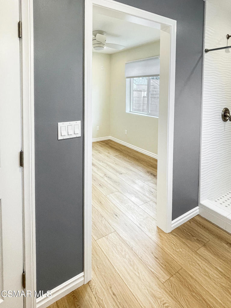 2142 Heywood Street, Unit A Simi Valley, CA 93065 - Photo 12 of 14 a view of an empty room with wooden floor and a window