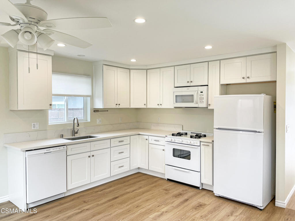 2142 Heywood Street, Unit A Simi Valley, CA 93065 - Photo 5 of 14 a kitchen with a white cabinets and wooden floor
