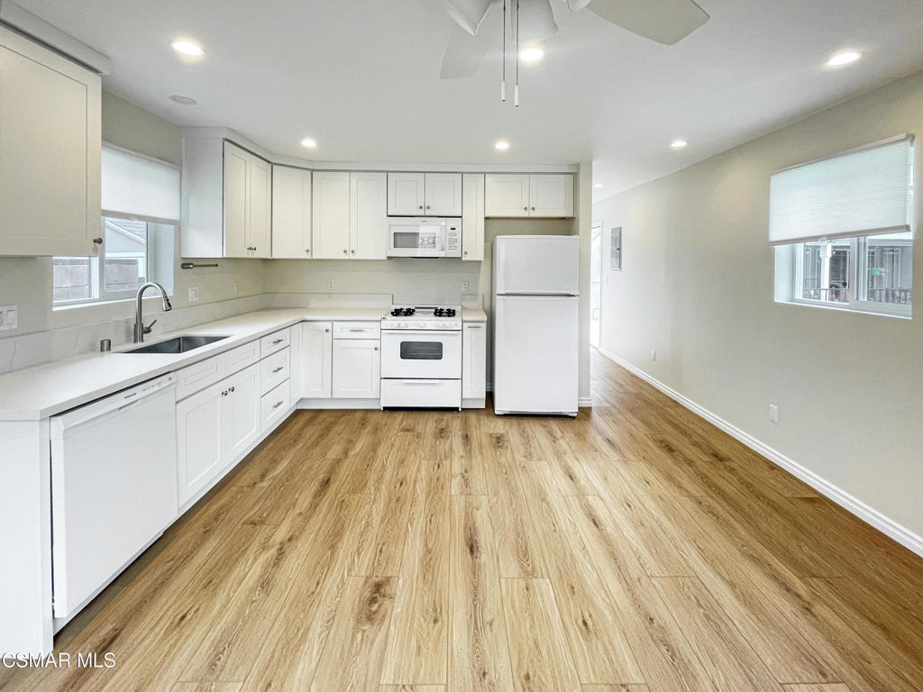 2142 Heywood Street, Unit A Simi Valley, CA 93065 - Photo 7 of 14 a open kitchen with kitchen island white cabinets and stainless steel appliances