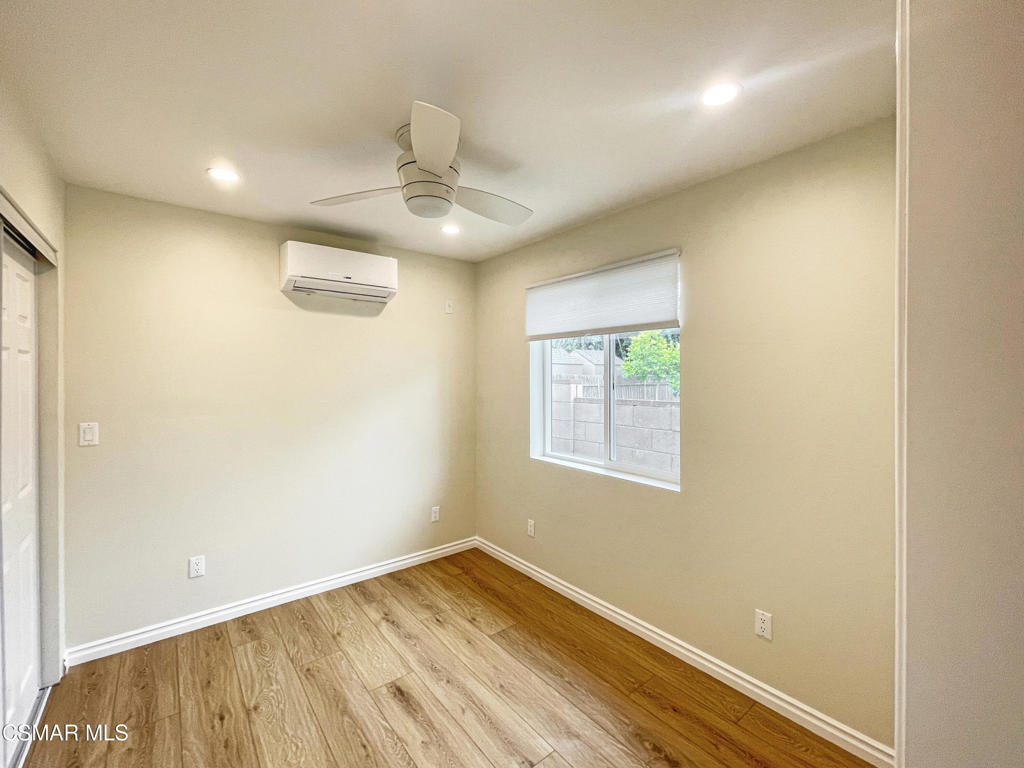 2142 Heywood Street, Unit A Simi Valley, CA 93065 - Photo 8 of 14 an empty room with wooden floor cabinet and a ceiling fan