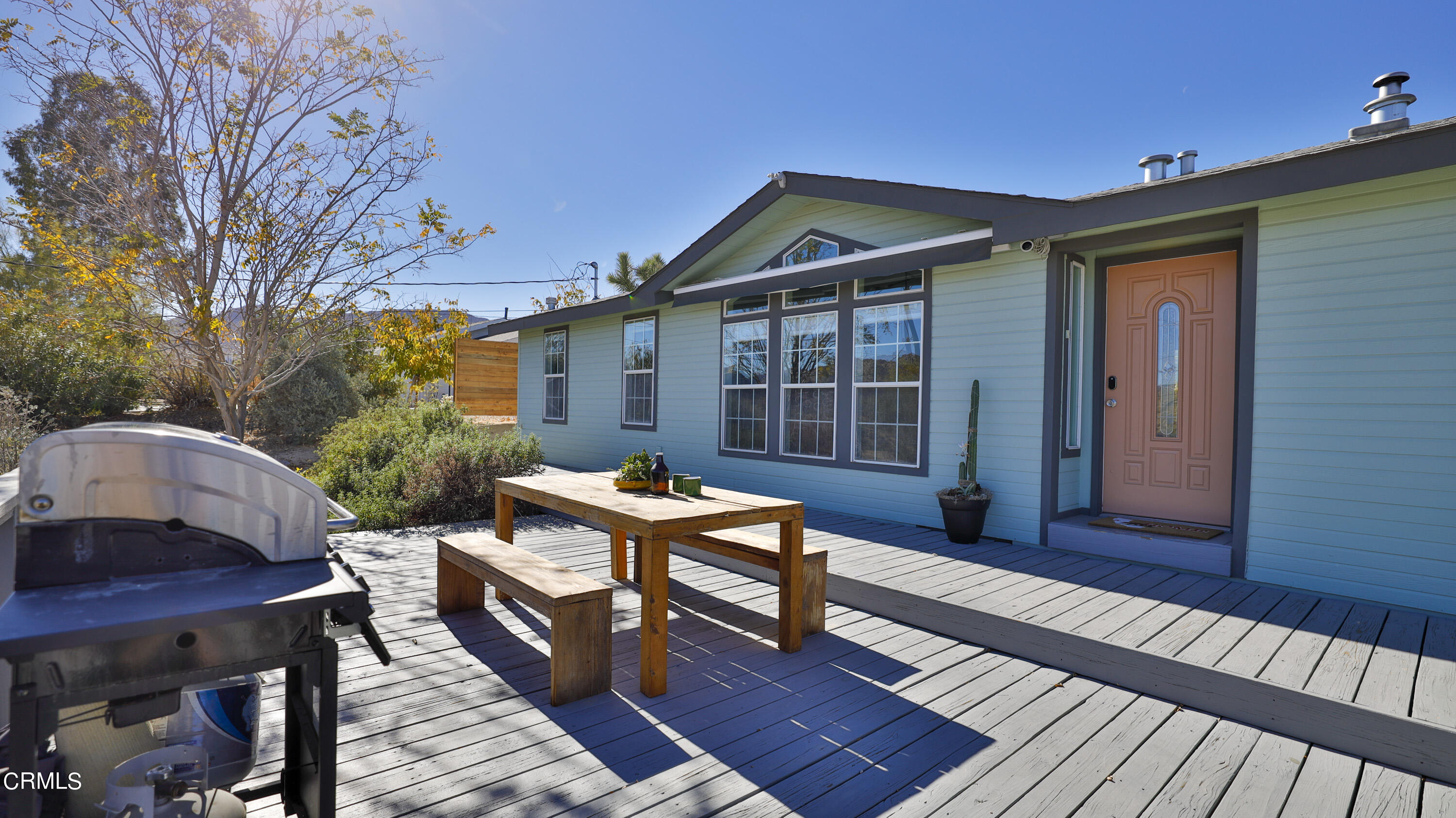 7354 Quail Springs Road Joshua Tree, CA 92252 - Photo 3 of 56 a backyard of a house with barbeque oven table and chairs