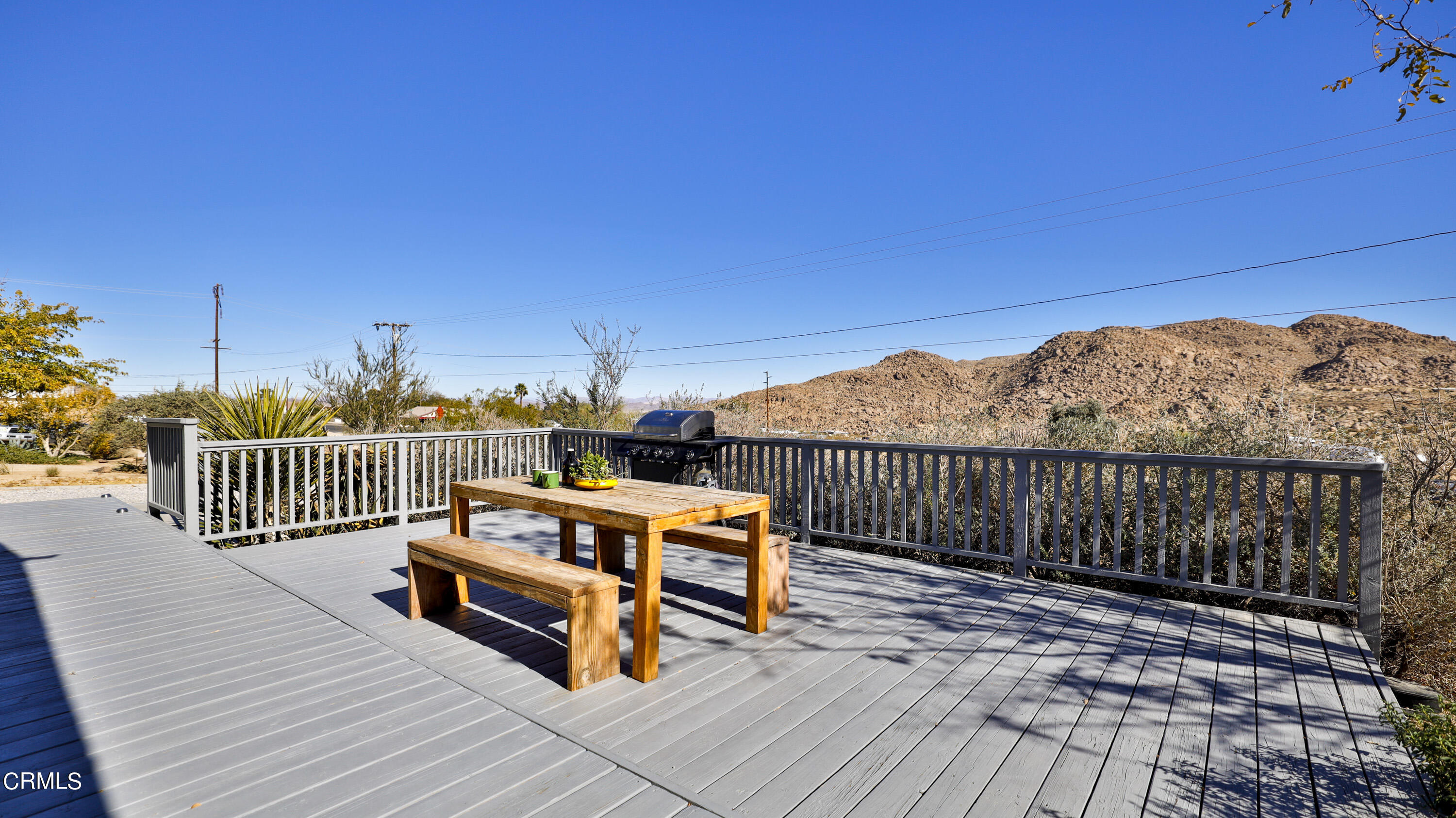 7354 Quail Springs Road Joshua Tree, CA 92252 - Photo 4 of 56 a view of a roof deck with wooden floor and fence