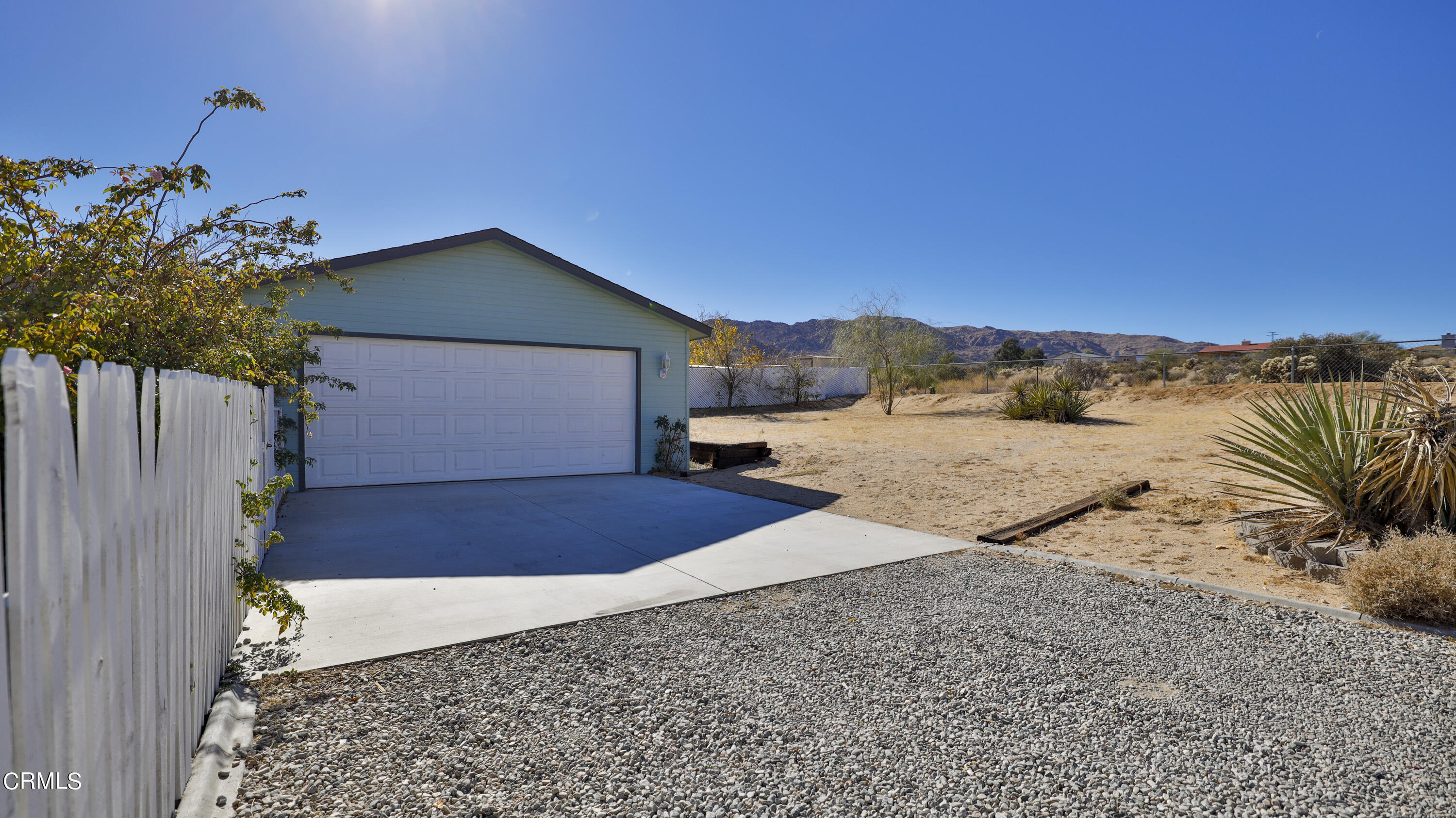 7354 Quail Springs Road Joshua Tree, CA 92252 - Photo 37 of 56 a front view of a house with a yard and garage