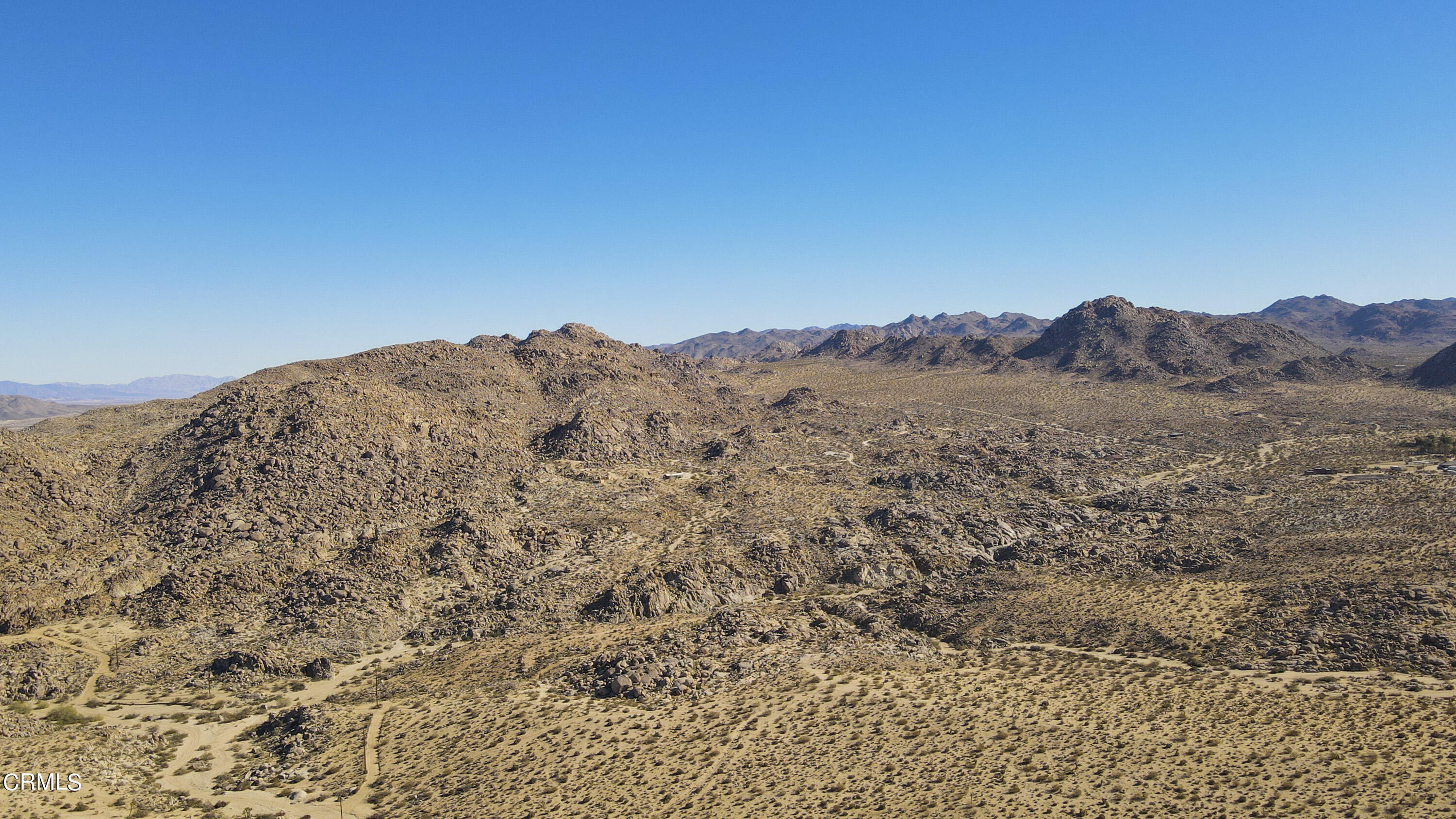 7354 Quail Springs Road Joshua Tree, CA 92252 - Photo 51 of 56 a view of a dry yard with mountains in the background