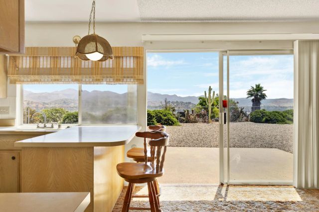 a view of a dining room with furniture wooden floor and a chandelier