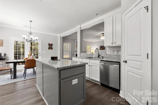a kitchen with stainless steel appliances granite countertop stove top oven and cabinets