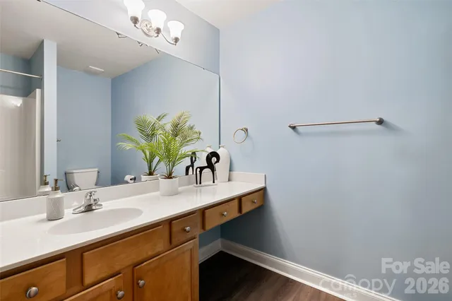 a bathroom with a sink vanity granite and a mirror