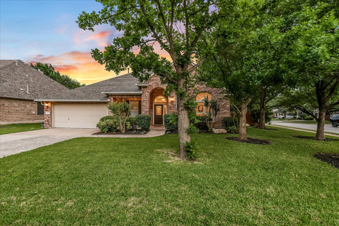 a front view of a house with a garden