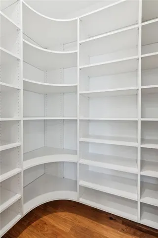 a view of walk in closet with empty racks