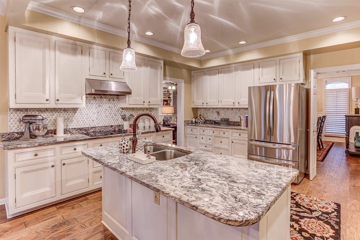 6648 Rue Beaumonde Drive Memphis, TN 38120 - Photo 11 of 20 a kitchen with stainless steel appliances granite countertop a sink refrigerator and cabinets