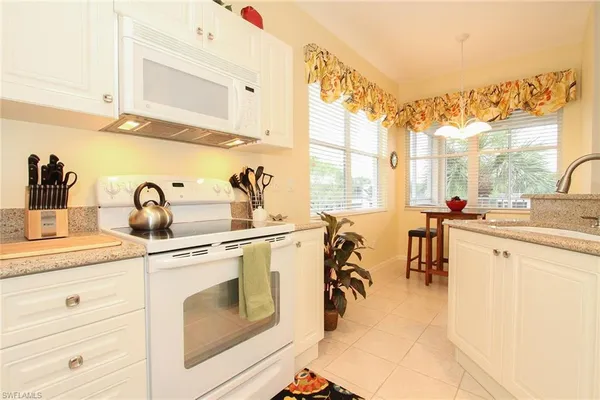 a kitchen with a sink and a refrigerator
